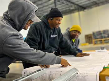 Walker J Walker workers looking at blueprints