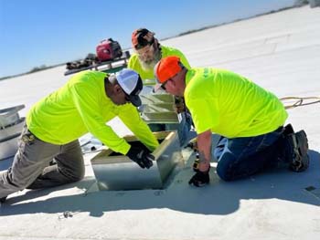 Employees working on a roof.